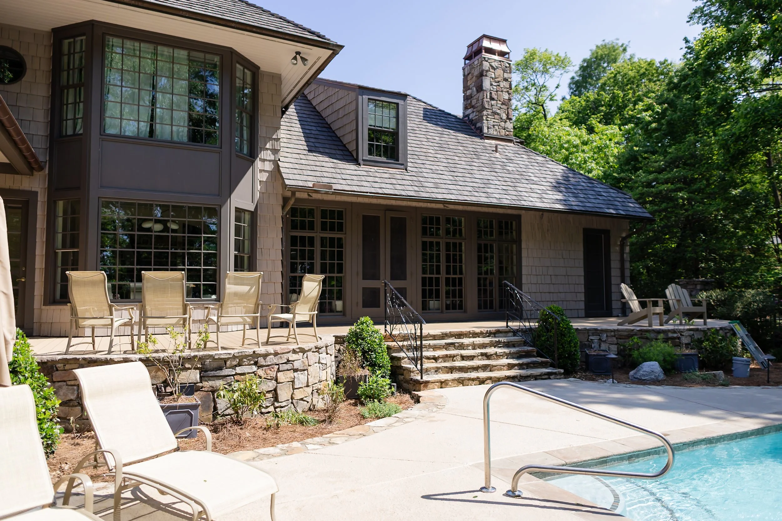 Wide-angle view of a raised custom timber deck remodel by Mims Construction on Lookout Mountain, highlighting the seamless transition from the house back entrance out across the entertainment terrace to the pool. 