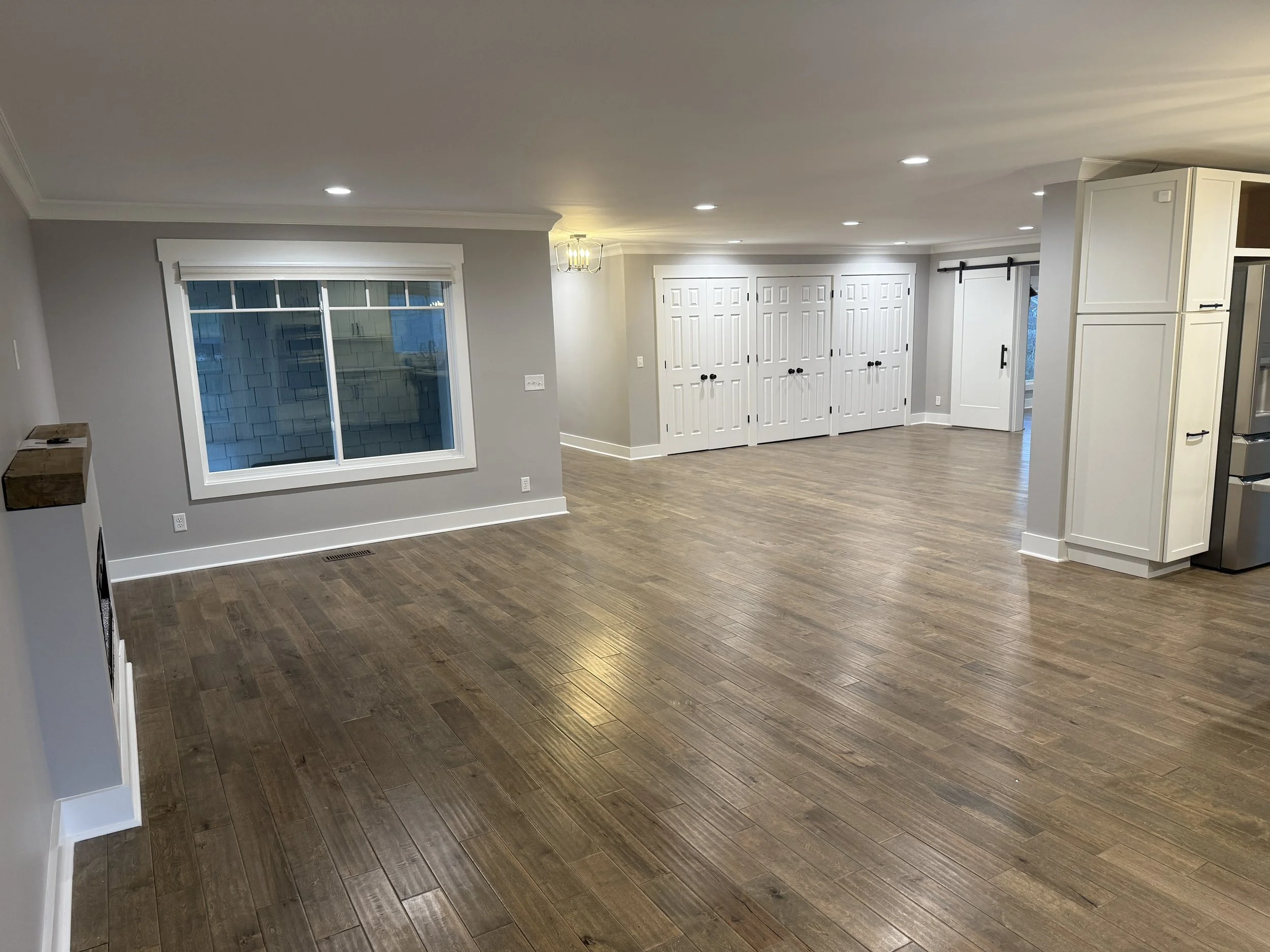 Comprehensive interior home layout transformation in East Hamilton near Collegedale TN, featuring high-end custom walk-in closet installations, architectural trim, precision hand-laid hardwood flooring, custom storage shelves, and rustic modern custo