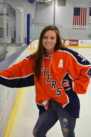 Brittany posing for photo in hockey arena