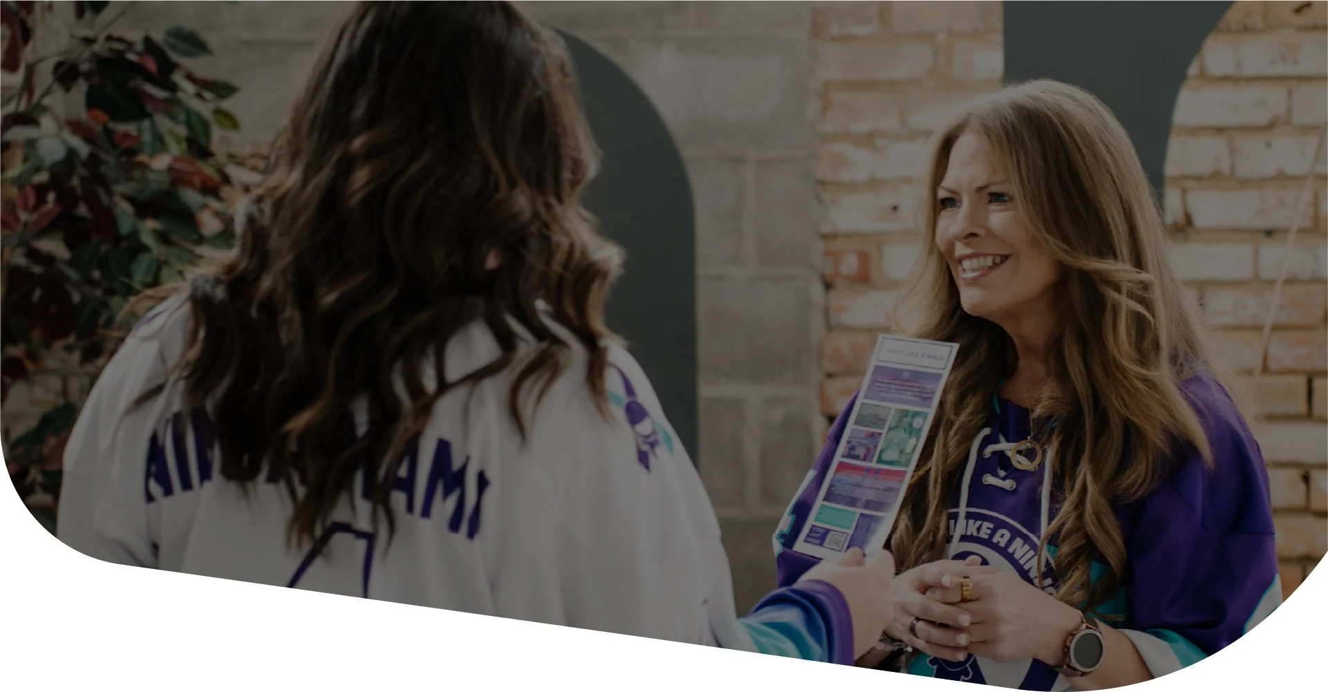 Angela (Ninja Mama) smiling and talking with another woman