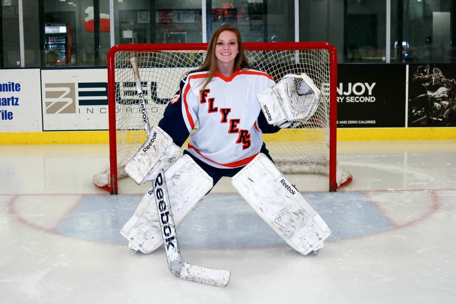 Brittany posing for photo in hockey arena
