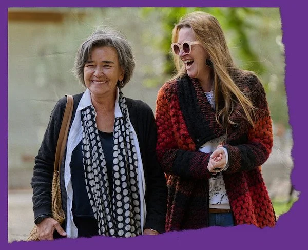 2 woman laughing together