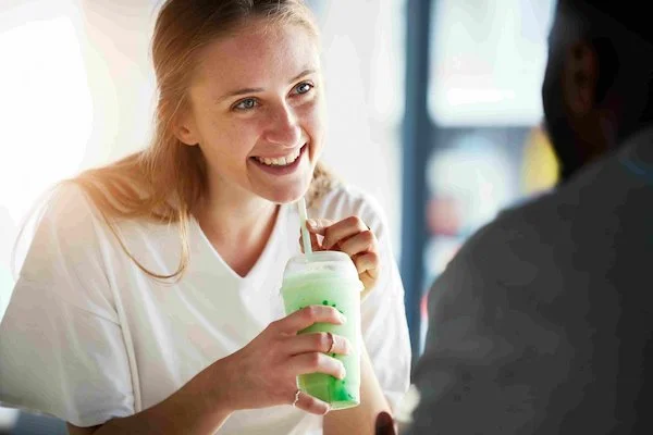 A girl drinking a Shamrock Shake