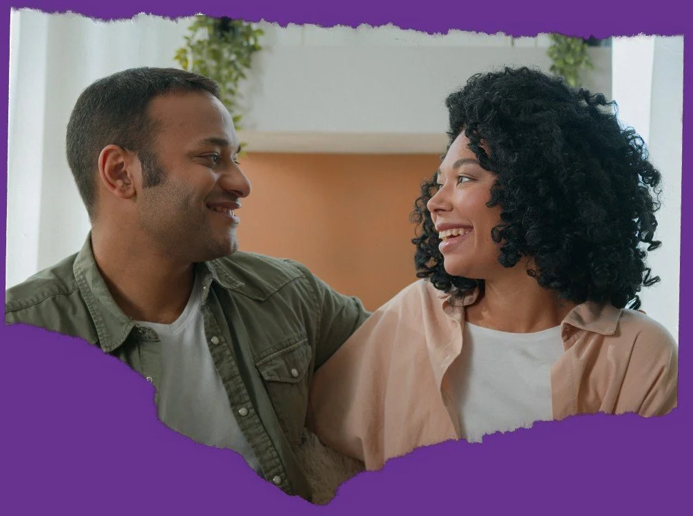 A man and woman smiling at each other