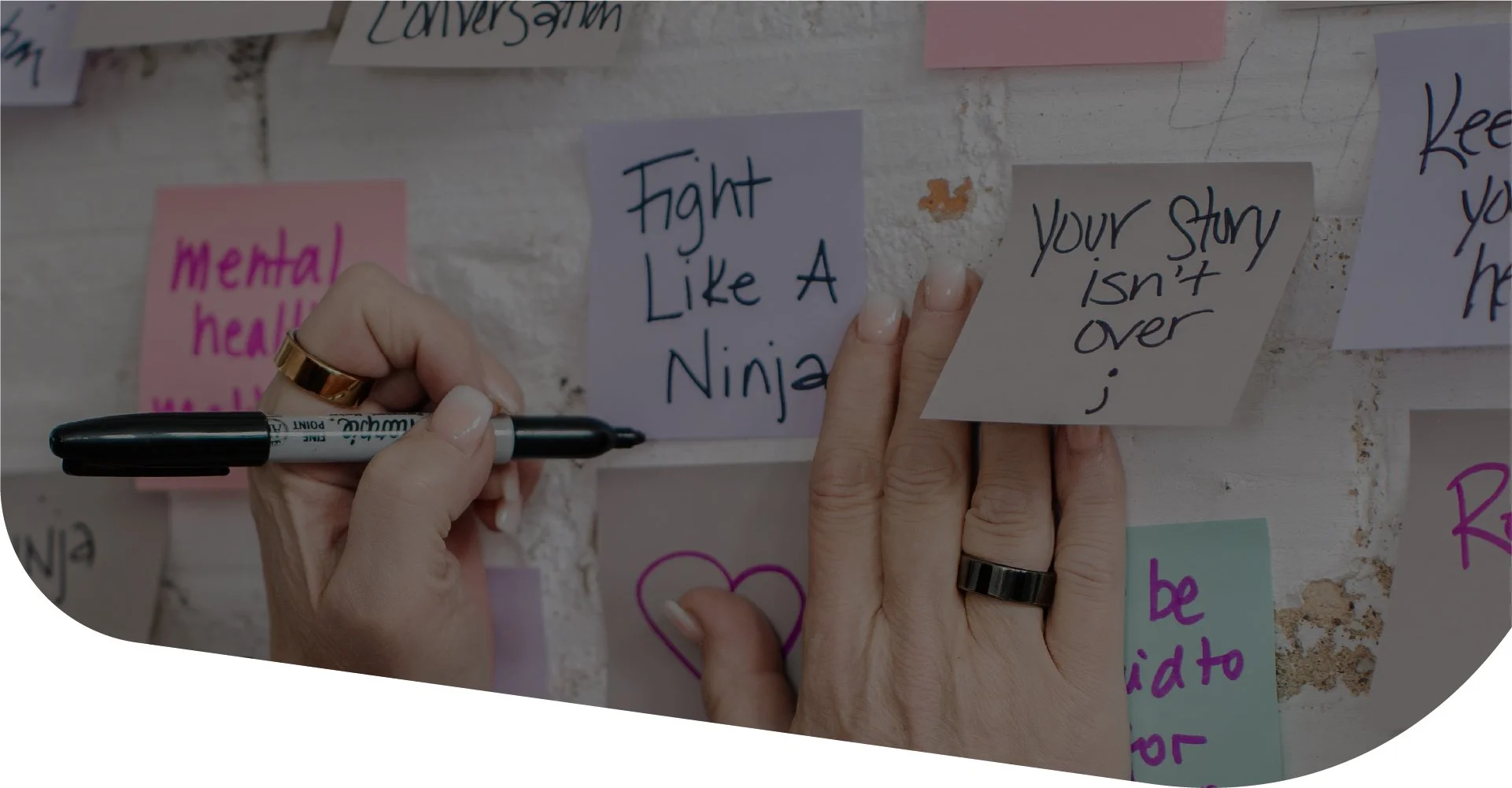 Someone writing Fight Like A Ninja on sticky notes