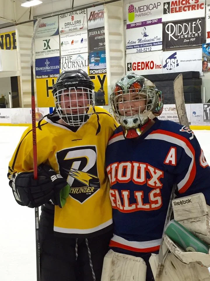 Brittany Drake and friend in their hockey uniforms