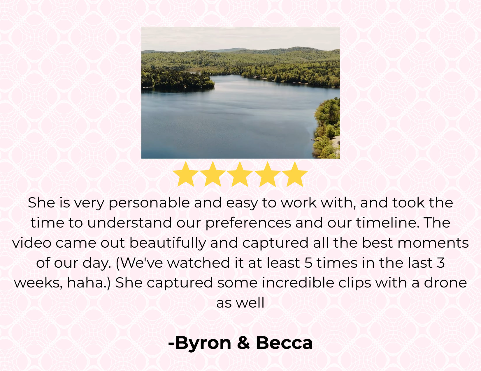 A scenic view of a lake surrounded by green trees and rolling hills under a cloudy sky.