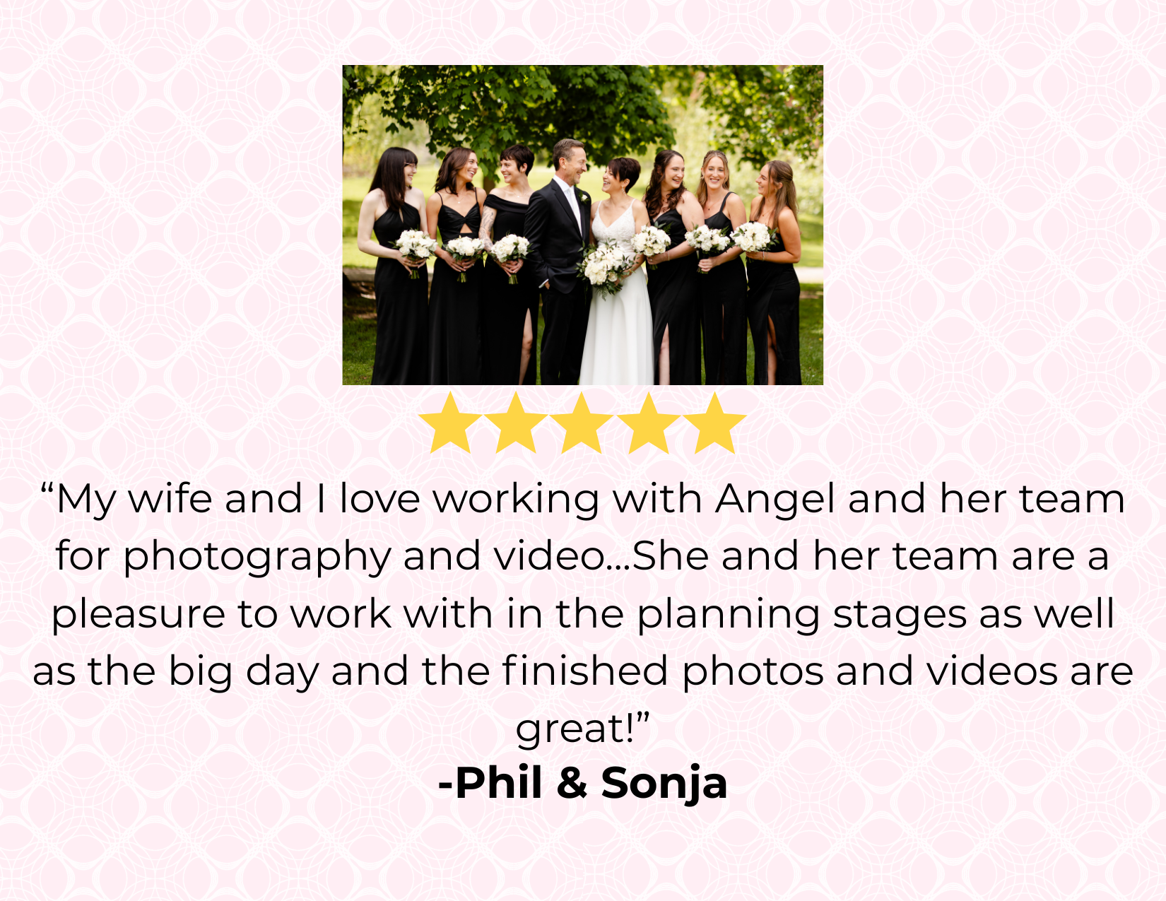 Group of people at a wedding, including a bride and groom with bridesmaids dressed in black, standing outdoors with trees in the background.