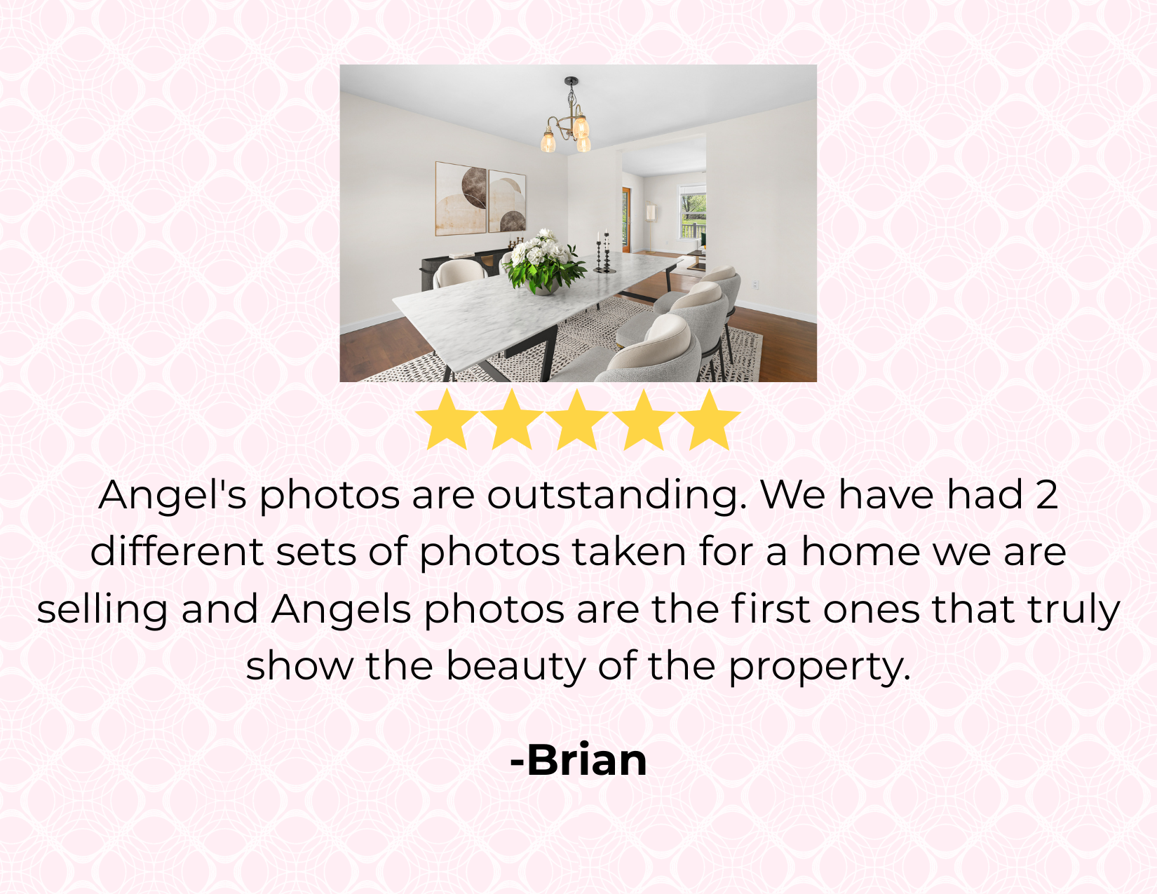 Photo of a modern dining room with a marble-top table, six white upholstered chairs, a black sideboard, abstract wall art, and a window with greenery outside.