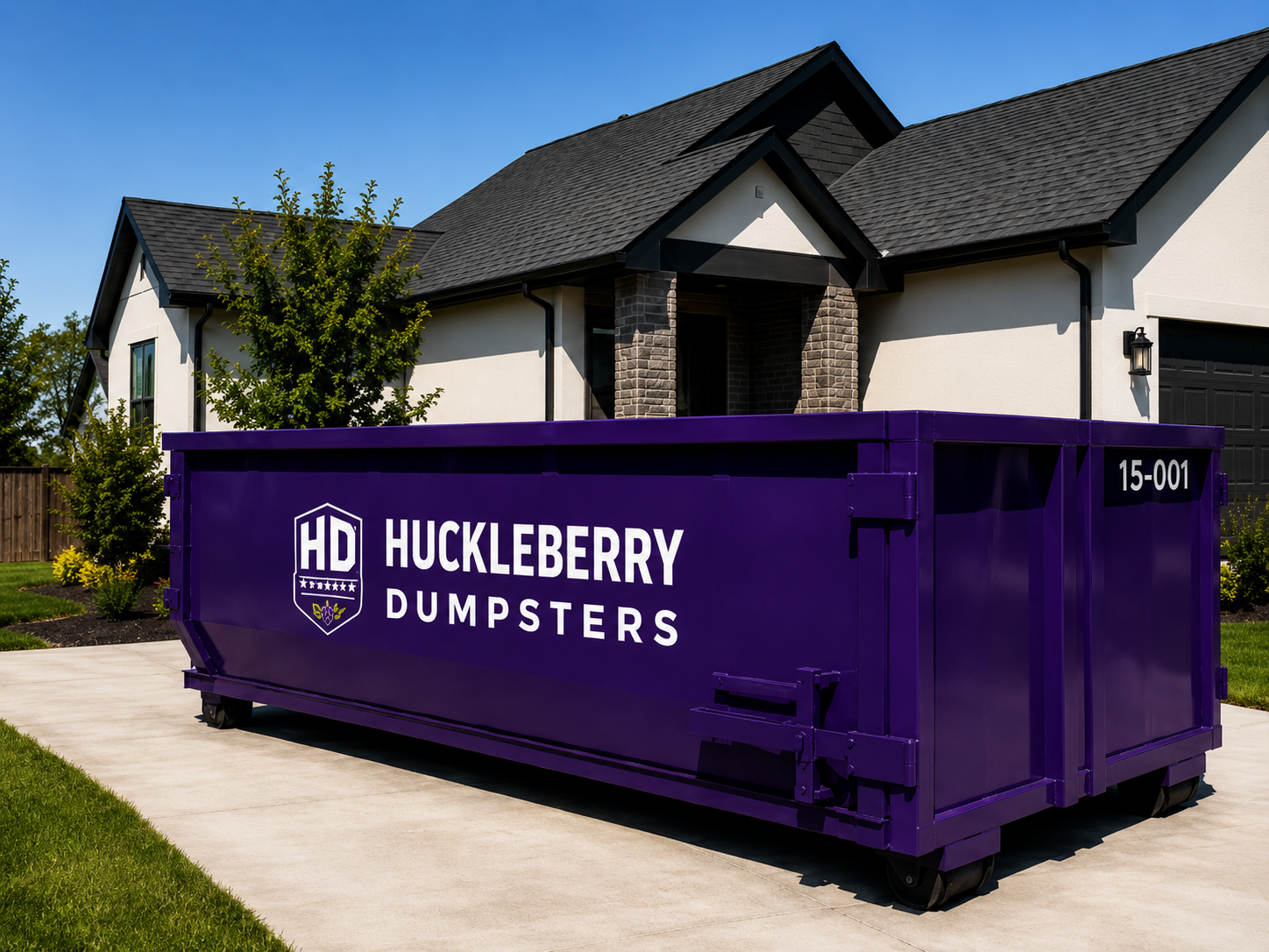 Purple Huckleberry Dumpsters 15-yard dumpster in a residential driveway