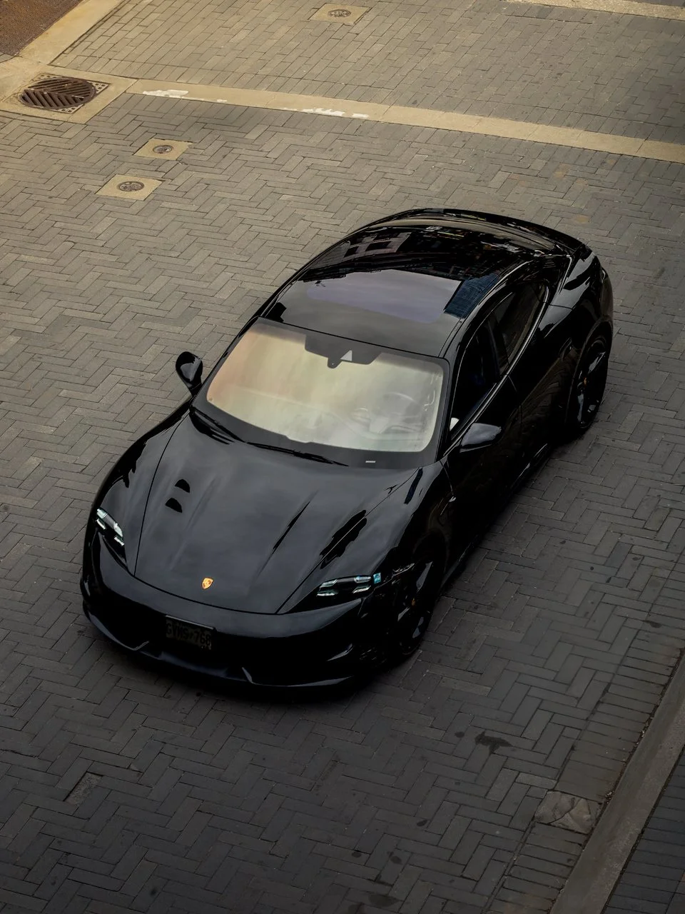 overhead-black-porsche-driving-yorkville-toronto.jpg