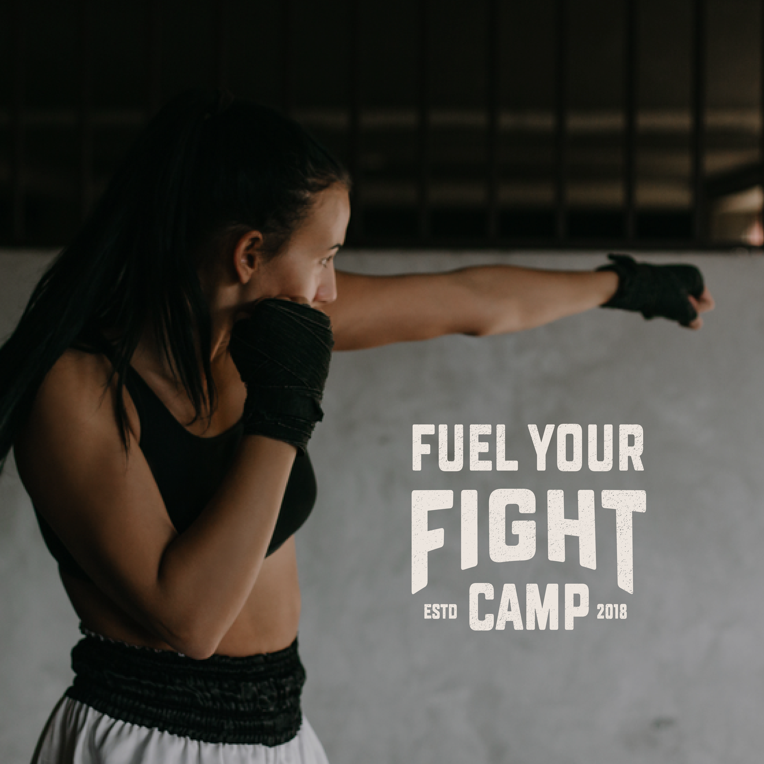 A MMA fighter woman shadow boxing with a logo reading "Fuel Your Fight Camp ESTD 2018"