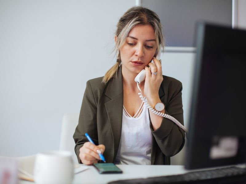 A Redding business owner using their VoIP phone system to make a phone call to a client