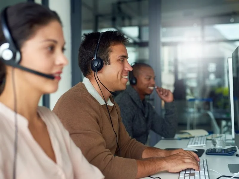 A team of sales representatives using a hosted phone system to make cold calls