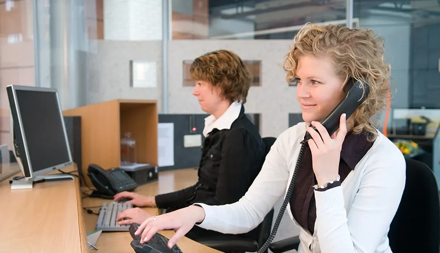 Office employees evaluating components of a new phone system