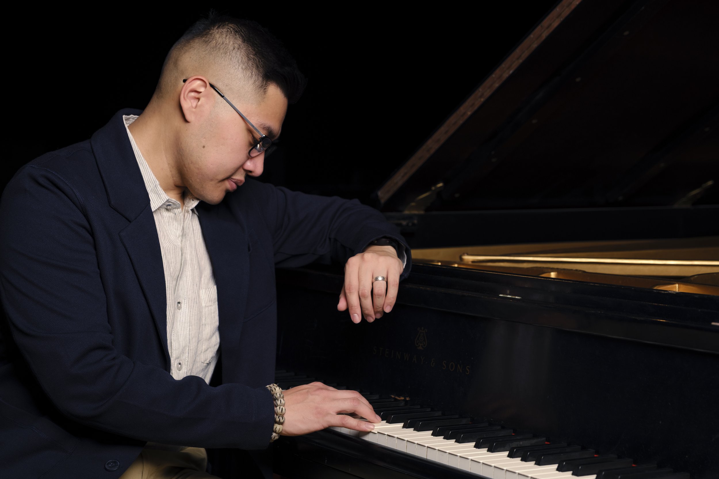 Piano student practicing chord progressions during a lesson