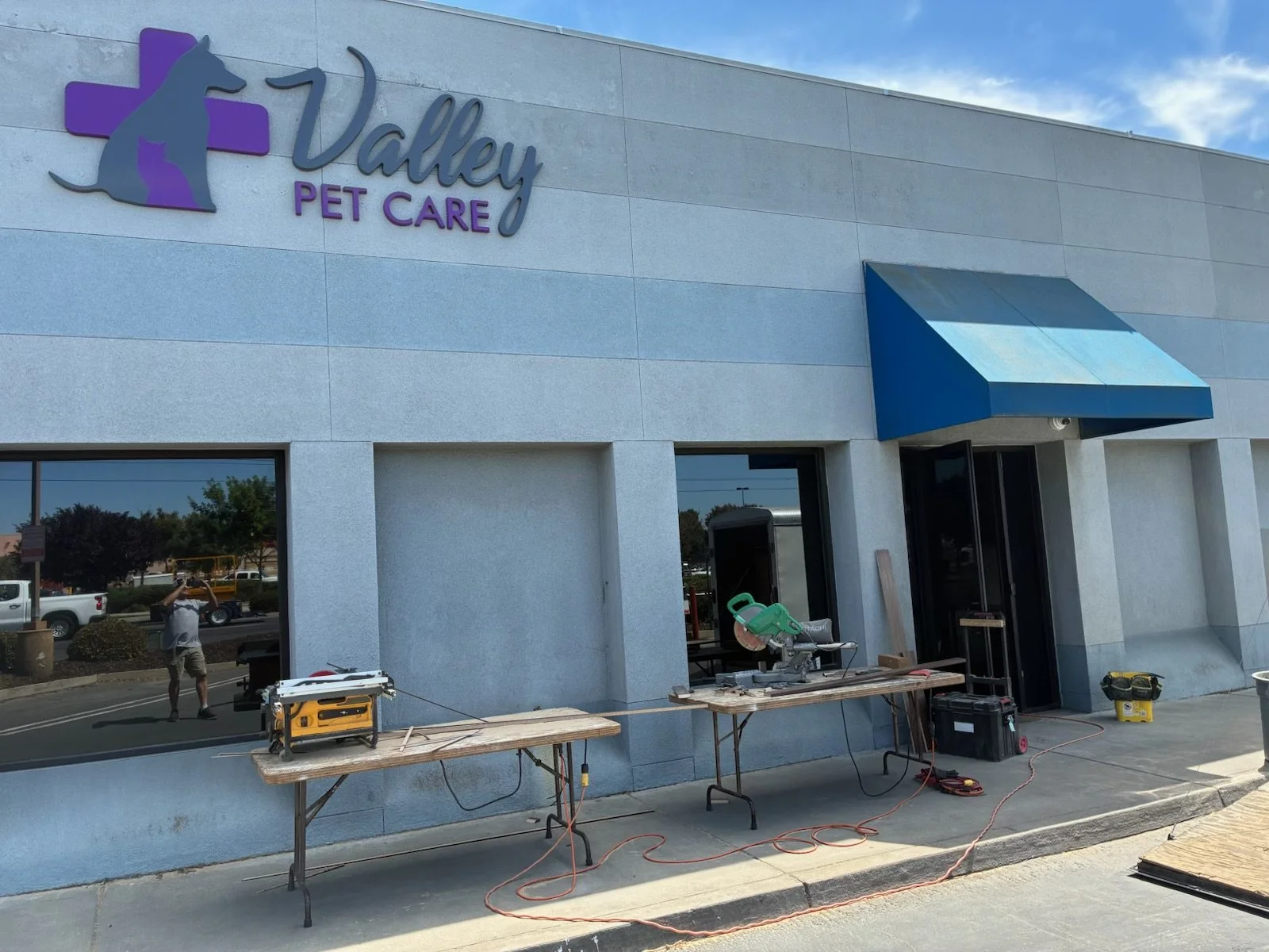 Exterior of Valley Pet Care building with construction tools and equipment on sidewalk in front.