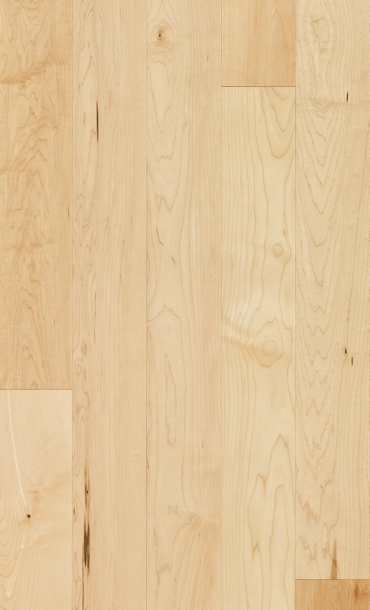 A close-up of a light-colored wooden floor with visible grain patterns and knots.