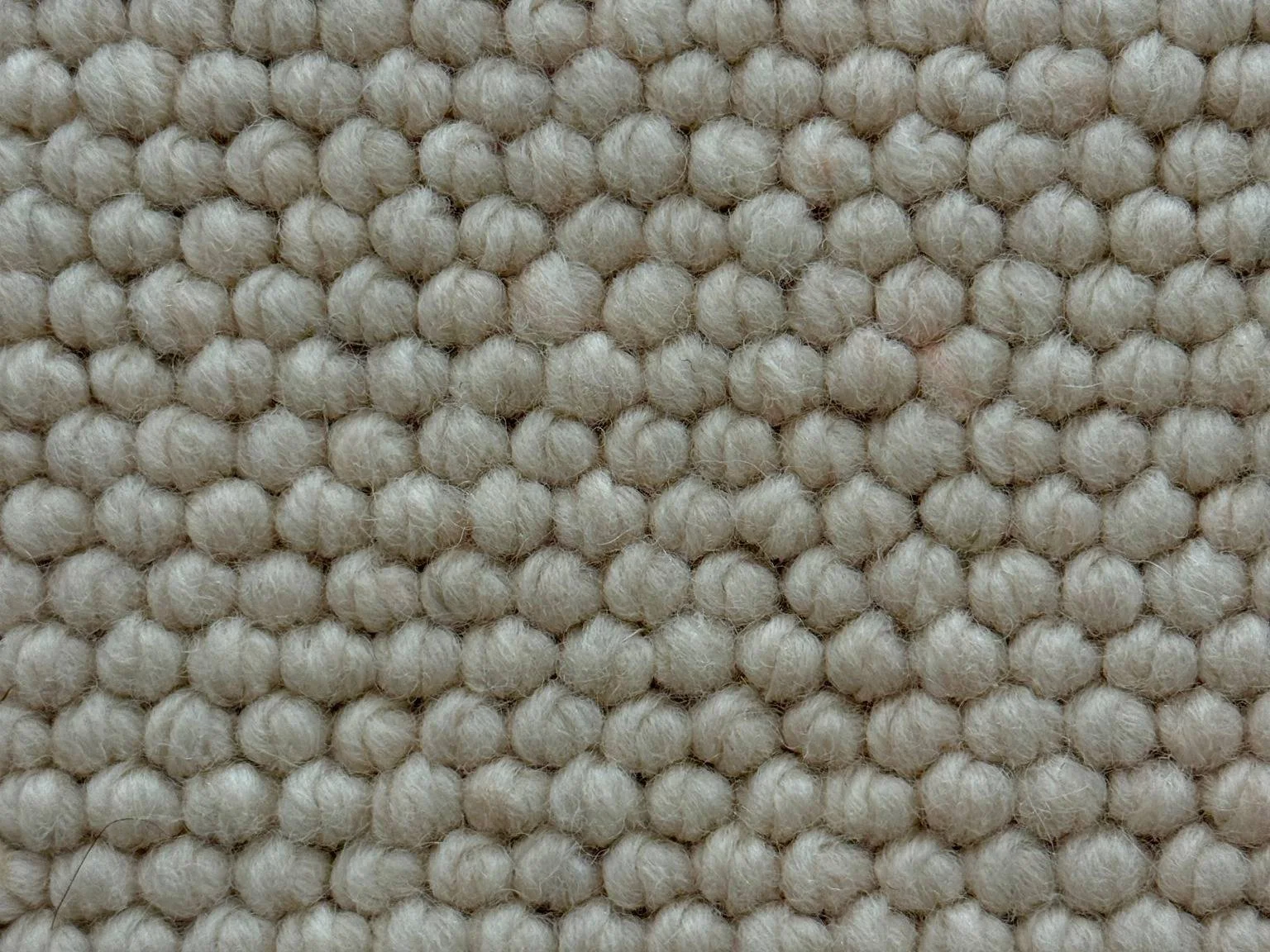 ligh grey and beige looped wool carpet with a tight weave pattern