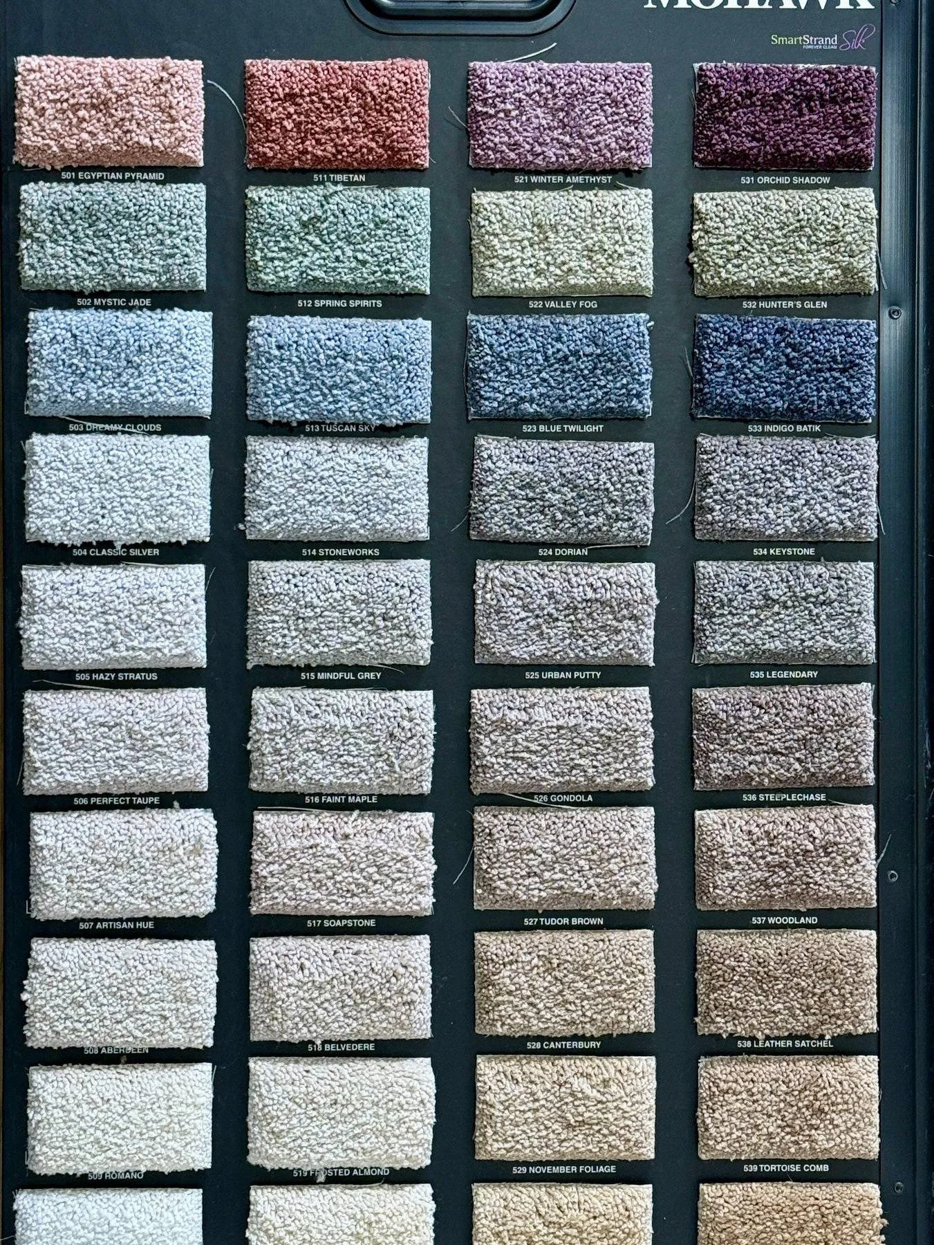 sample board of mohawk smart strand carpet with 40 different colors.