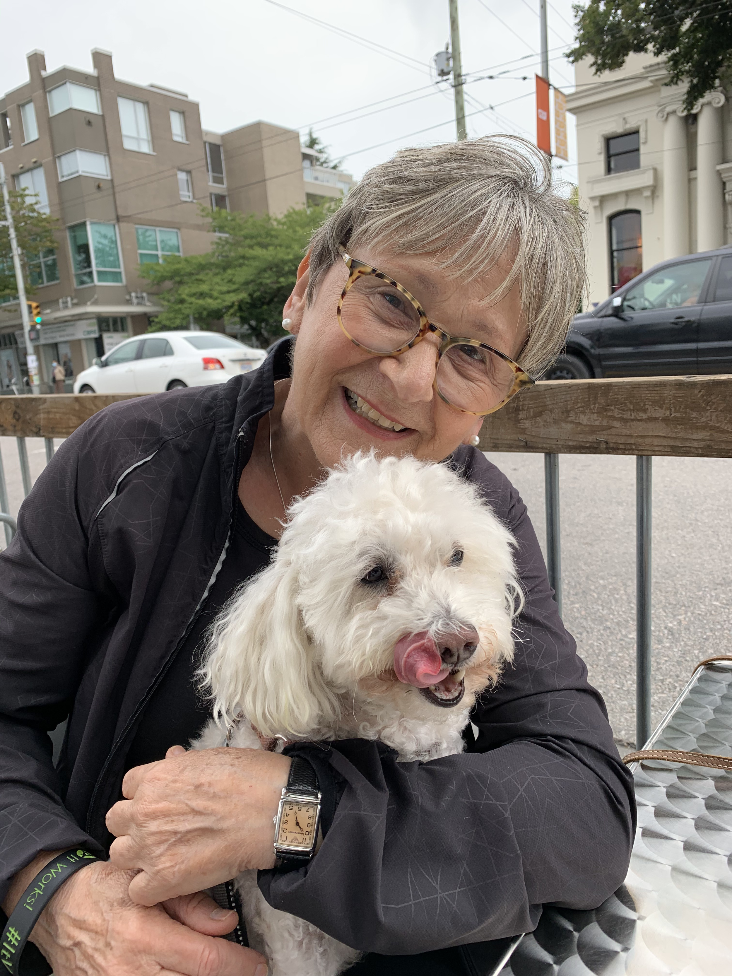 Woman holding dog and smiling