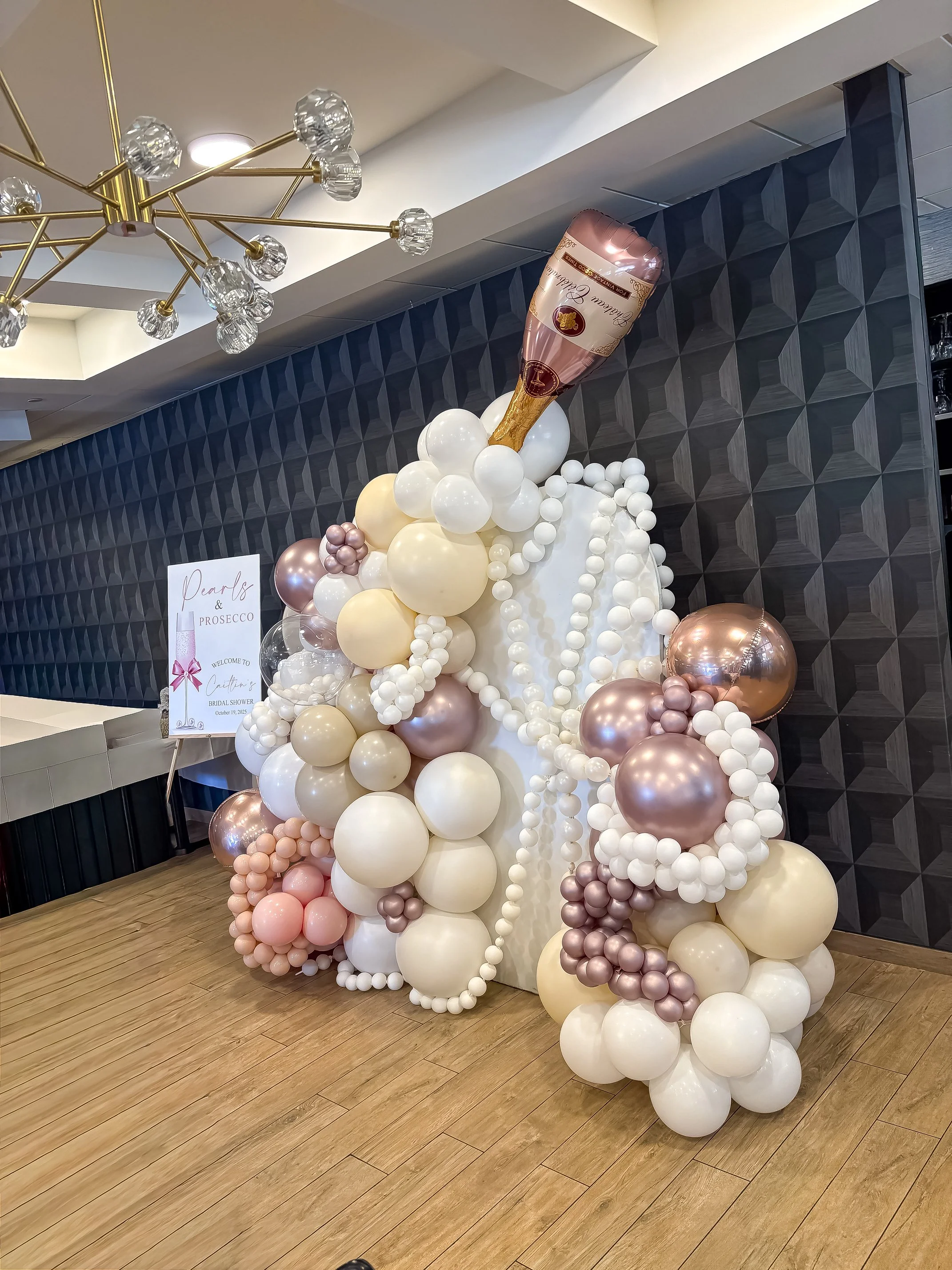 Colorful beach scene with umbrellas, parasols, and people relaxing near the shoreline under a clear blue sky.