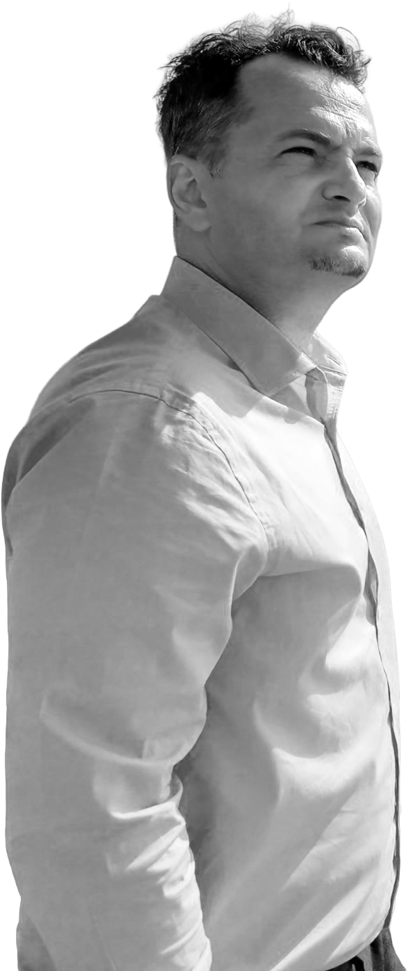 Eugen looking to the right, wearing a button-up shirt, with a serious expression, in black and white.