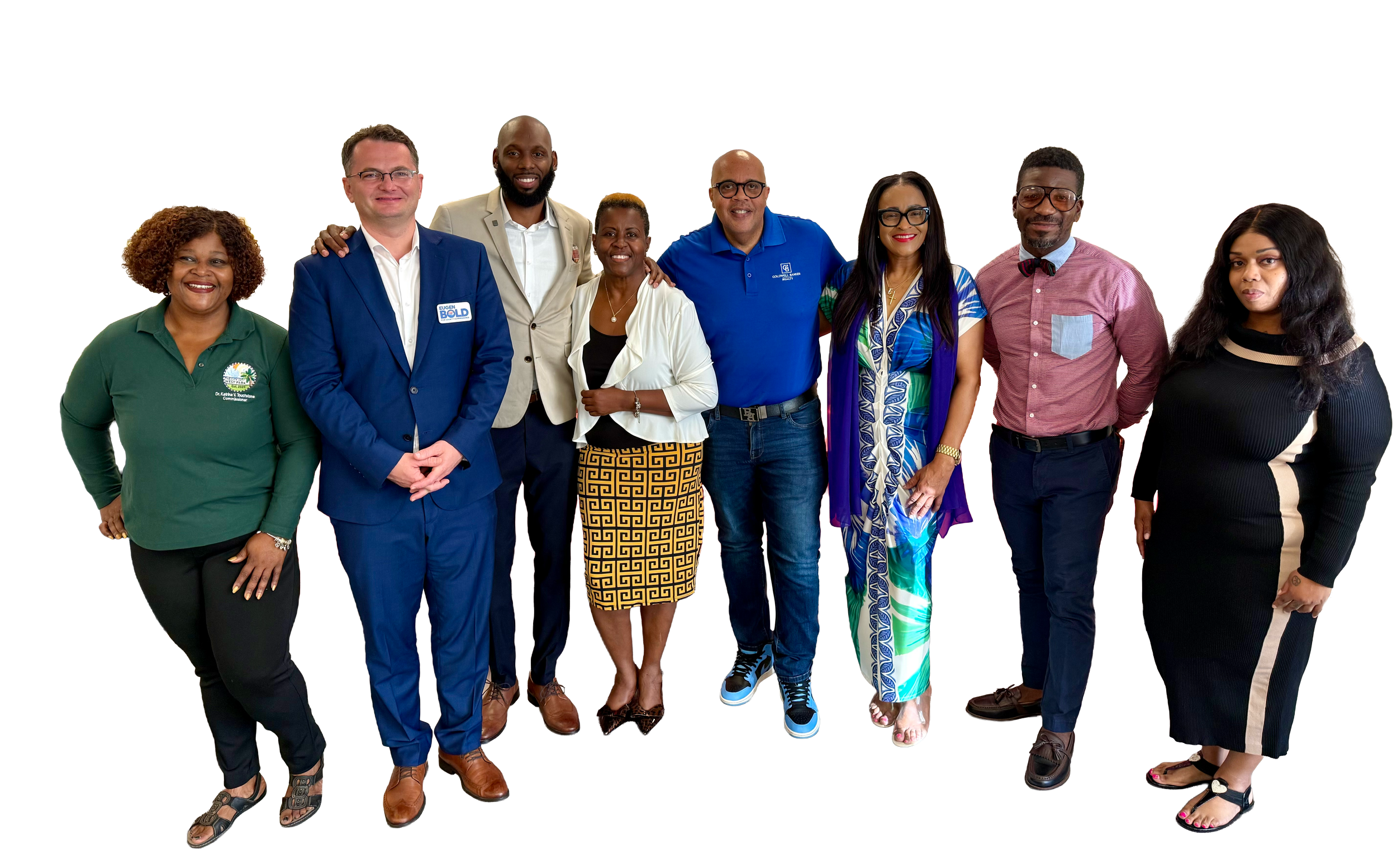 Group of nine diverse professionals posing for a photo in an indoor setting.