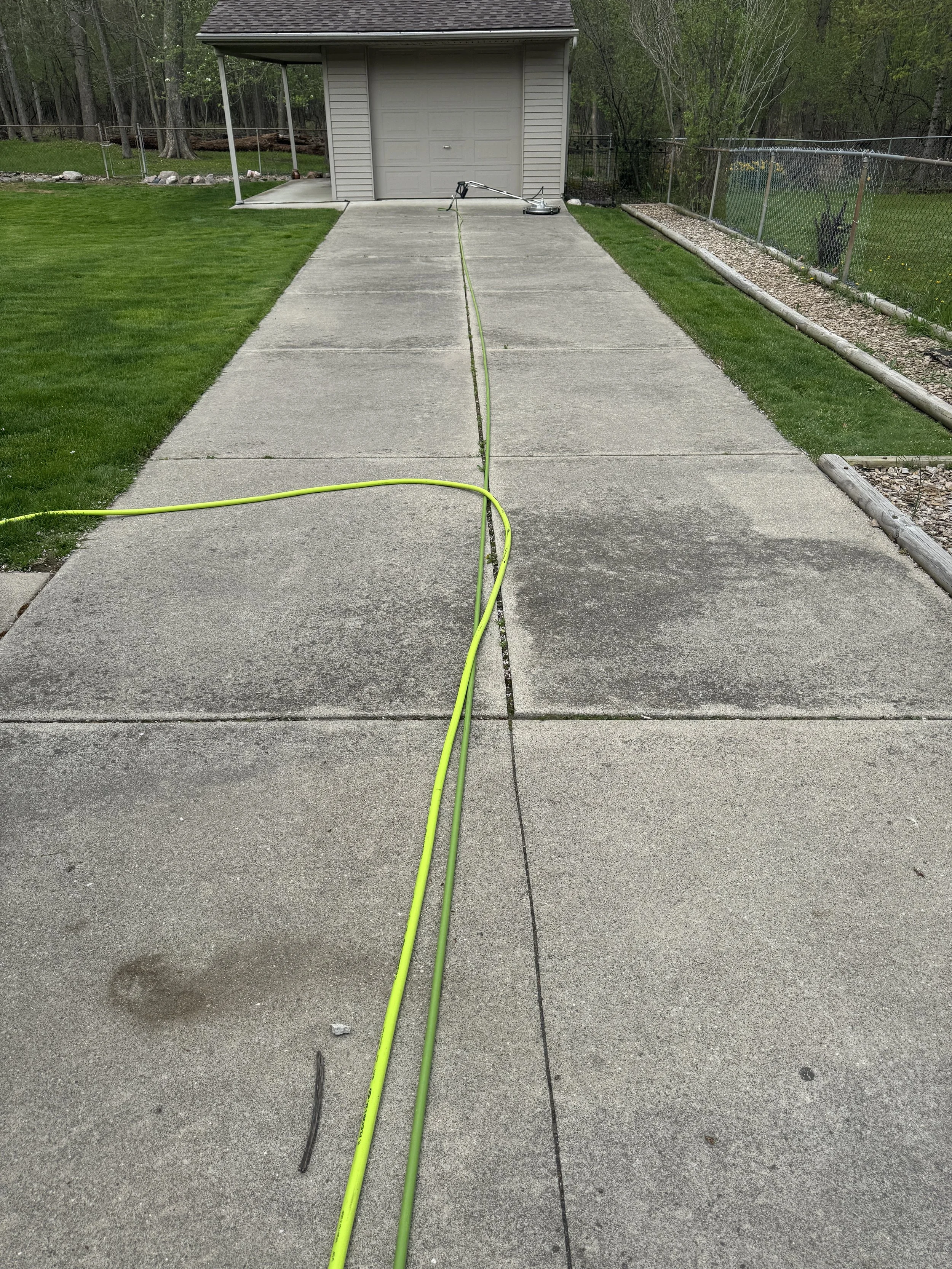 Concrete driveway before cleaning – wide view in Wayne County, MI | Island Shine