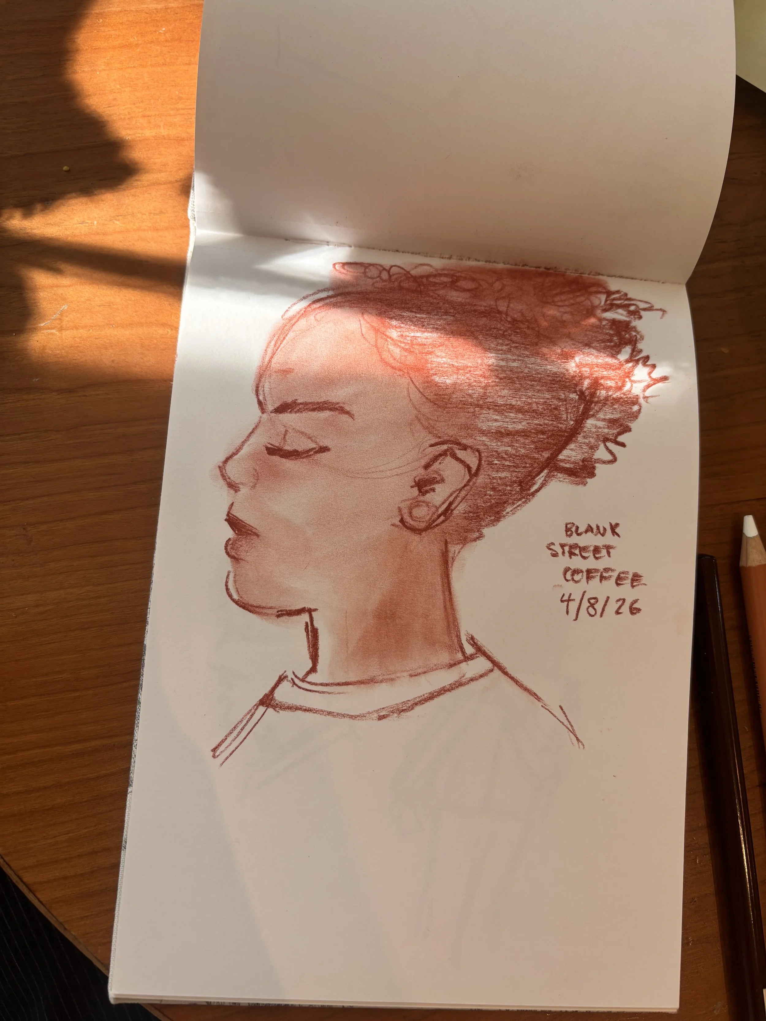  A drawing of a young woman done in conte pencil. 