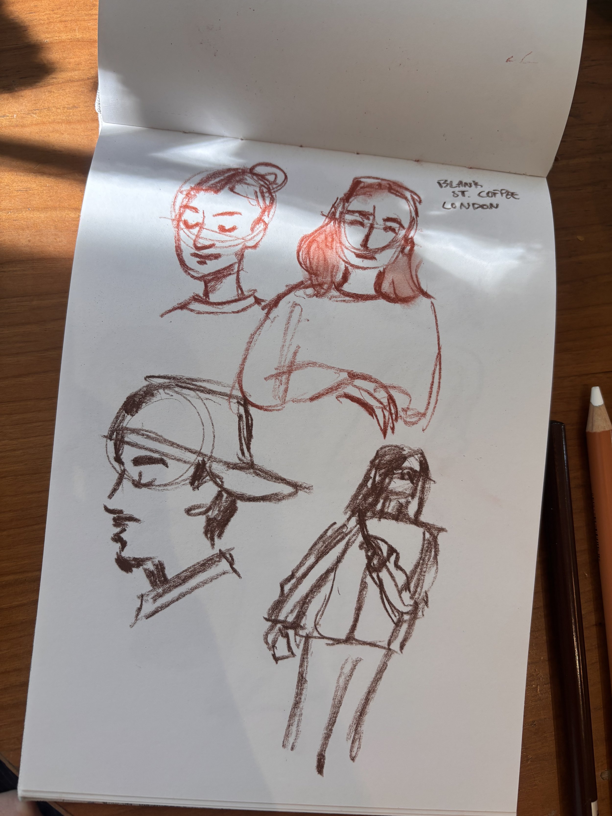  Live sketches done at a cafe in London done in conte pencil. 