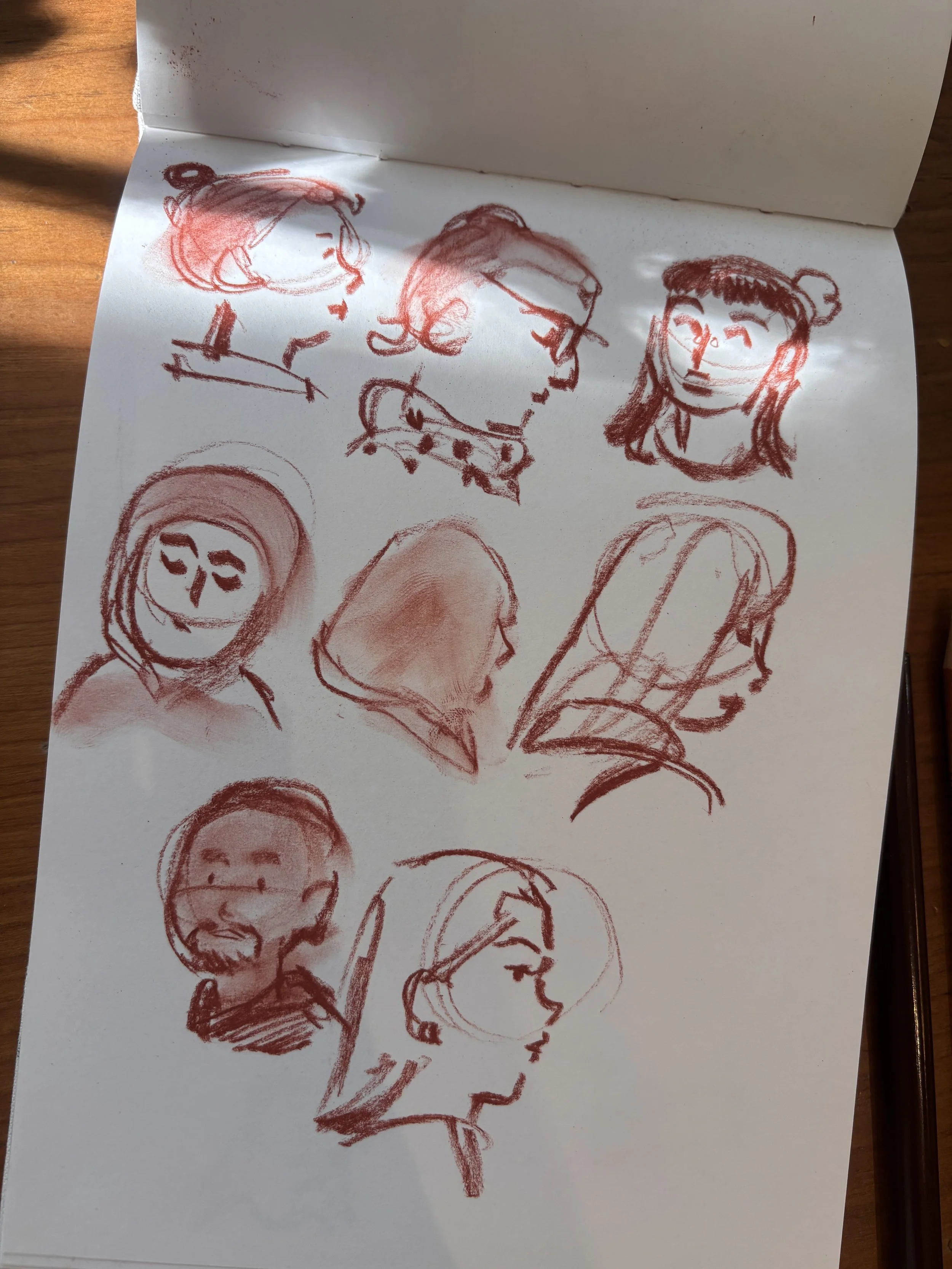  Conte pencil sketching done in London. Series of faces done in a cartoon style.  