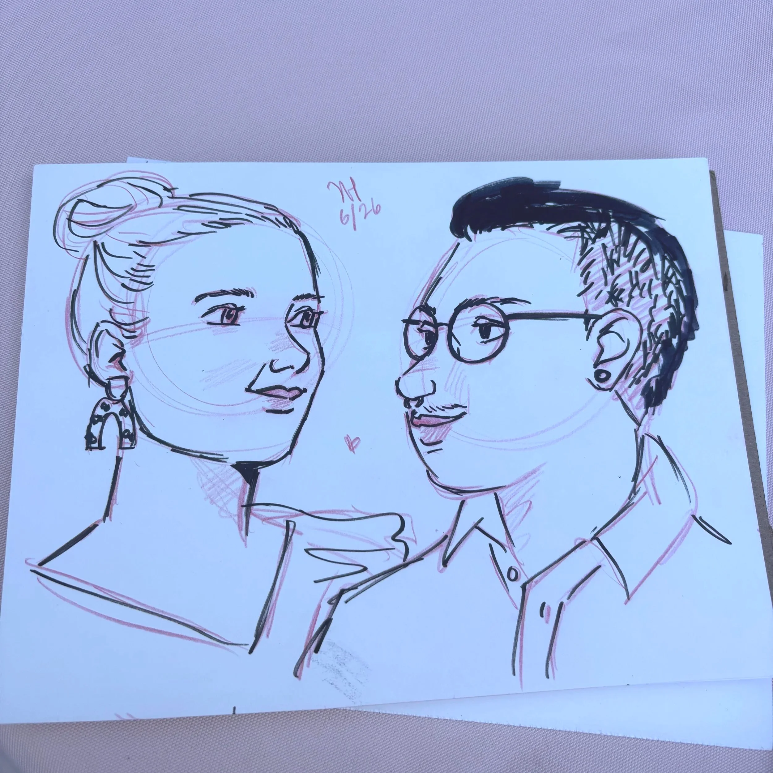 A black pen and red pencil live portrait illustration of a guest couple at a wedding.