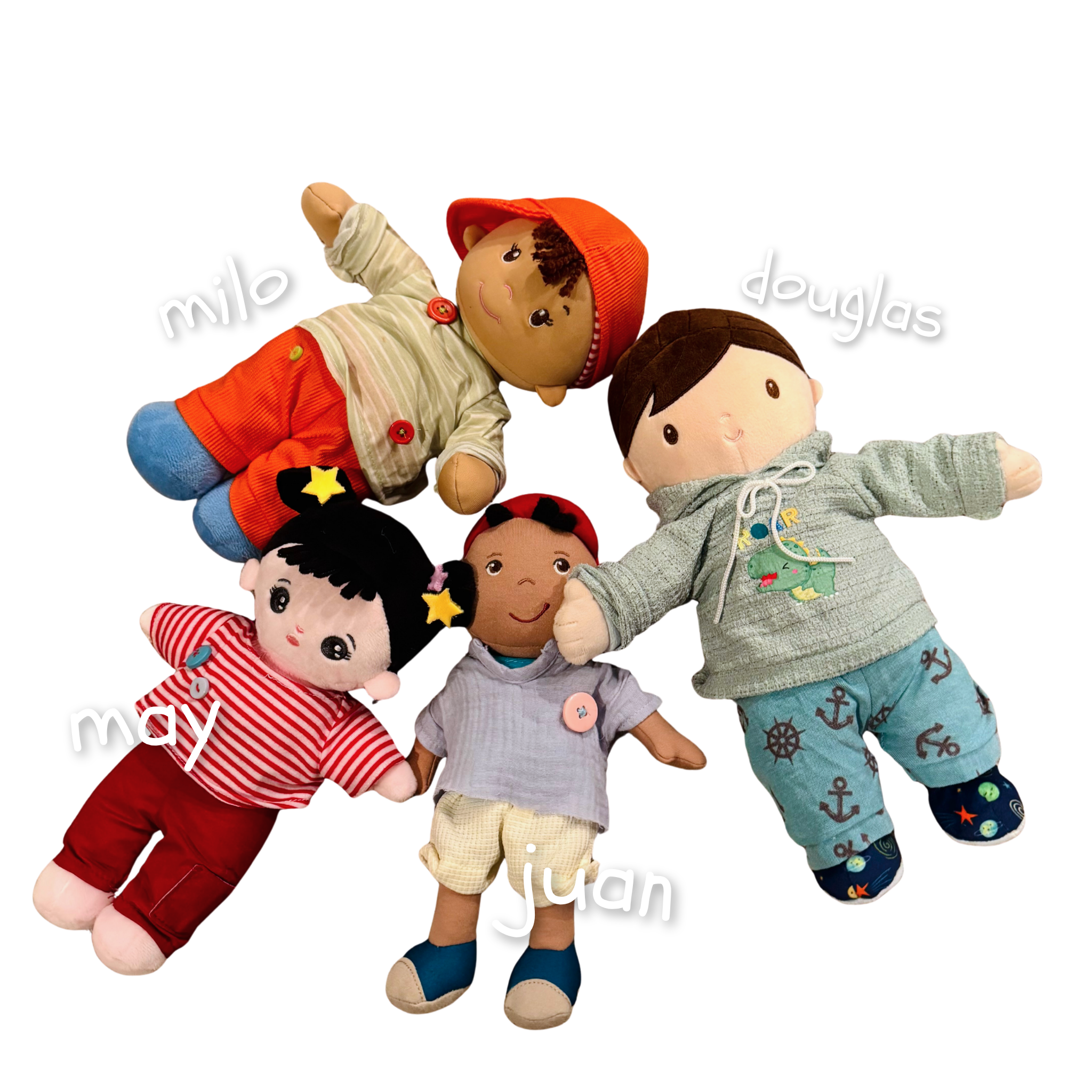 Group of plush toys including a boy doll named Milo, a girl doll named Lucy, and two other dolls, lying on a dark surface with calendar dates for April, May, June, and July visible.