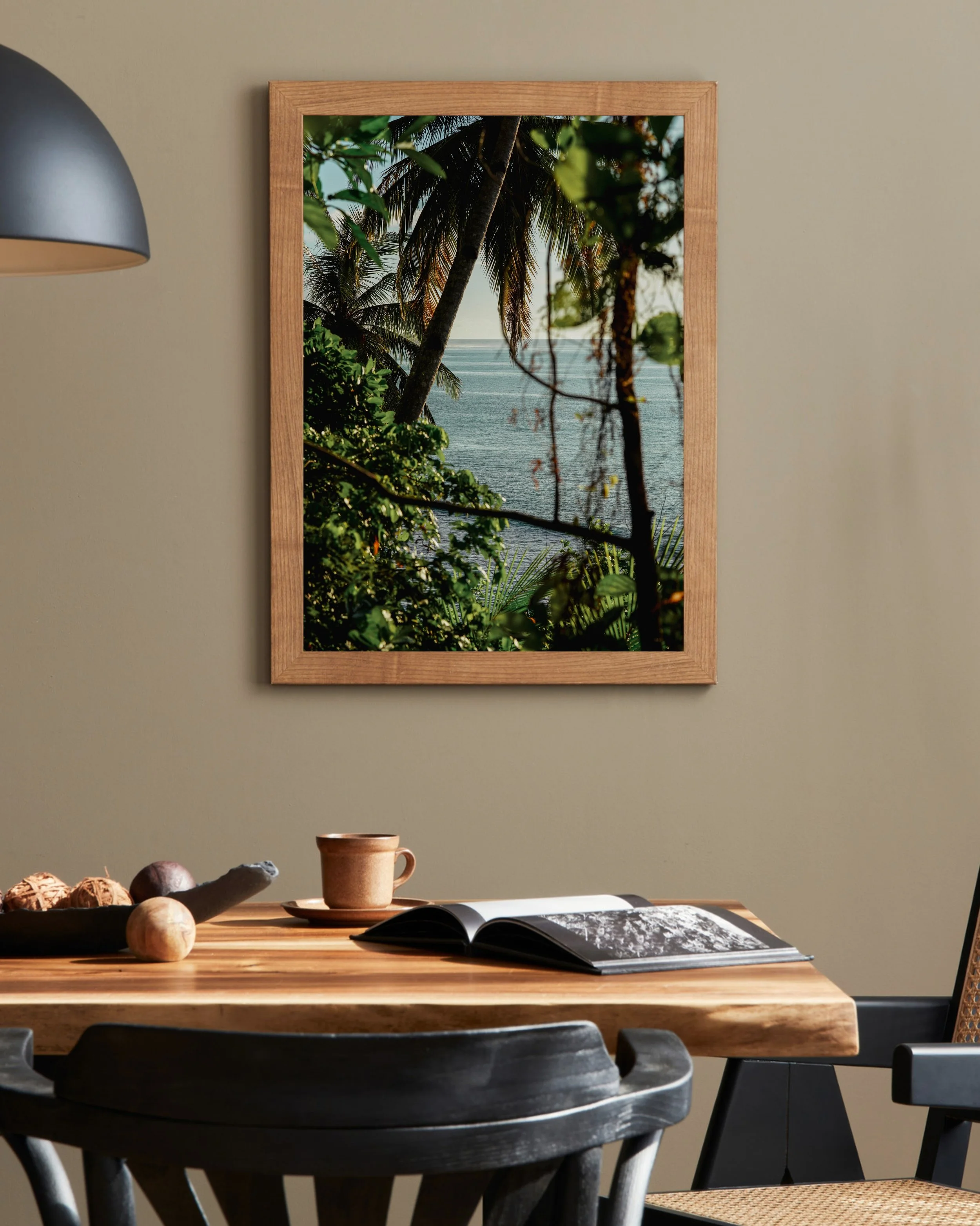 Minimalist kitchen with tropical ocean photography print framed by palm trees in the Mentawai Islands, Indonesia