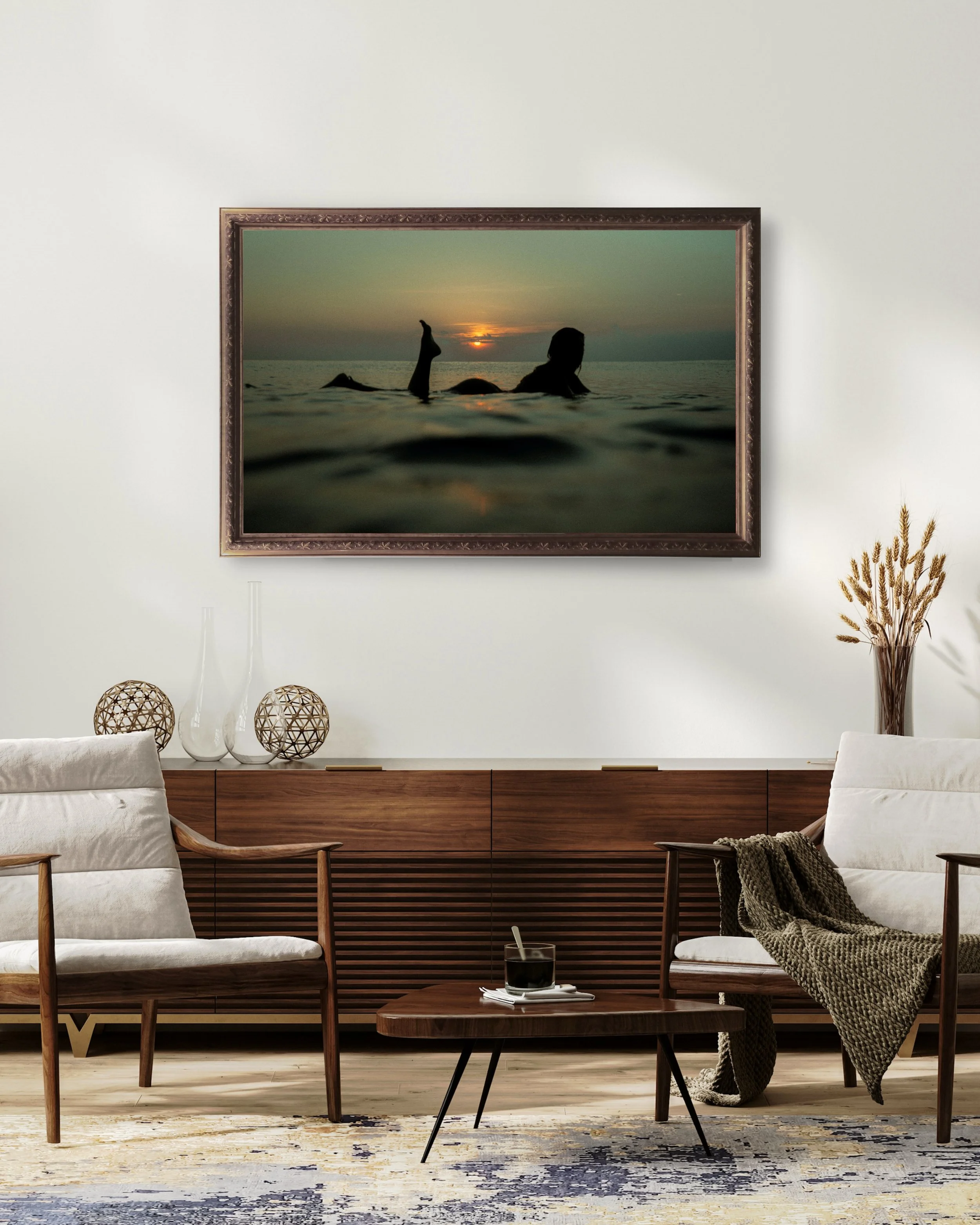 Surf photography female sunset surfer wall art print displayed in minimalist living room interior
