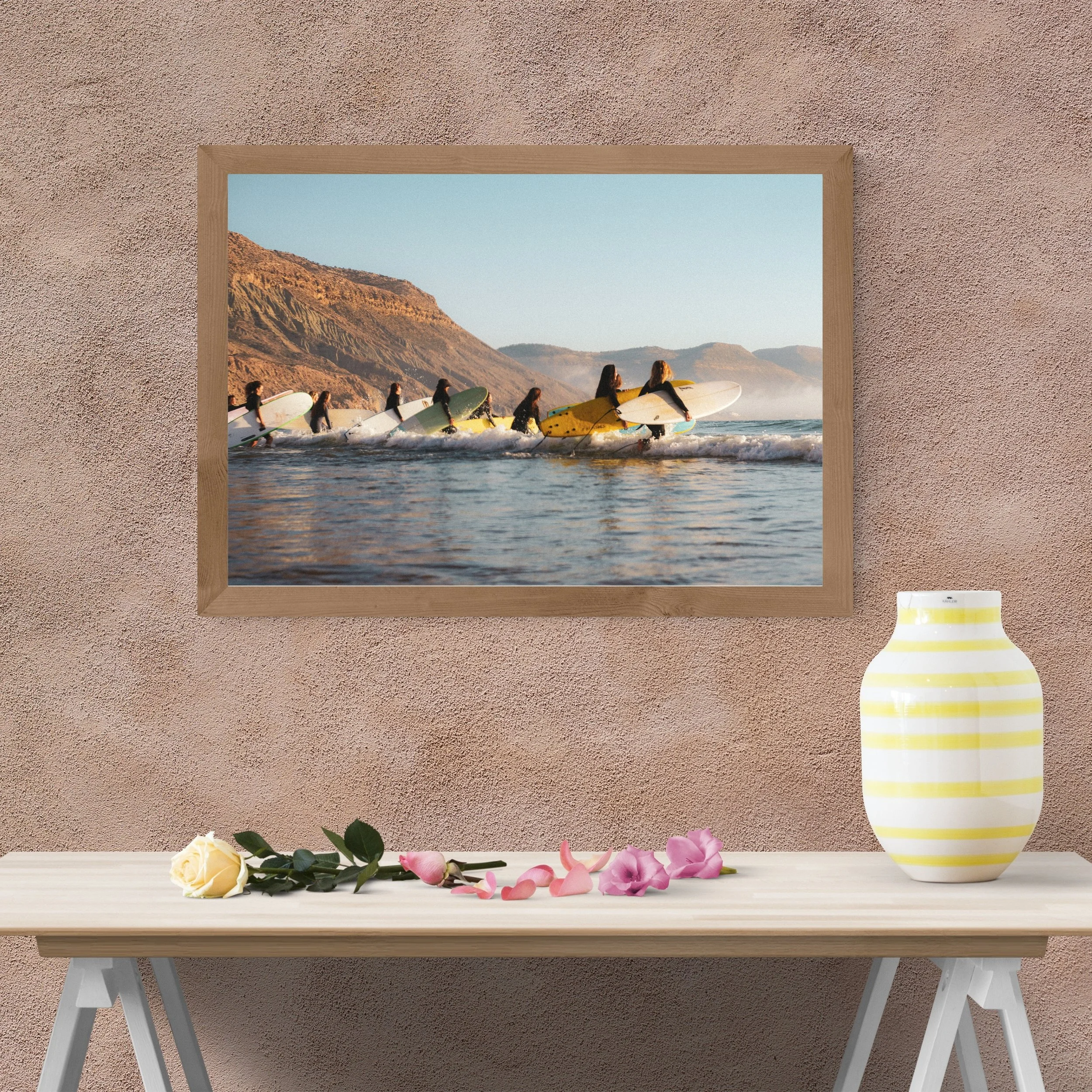 Surf lifestyle photography print of female surfers entering the ocean at sunrise with coastal mountains of Imsouane Morocco home decor