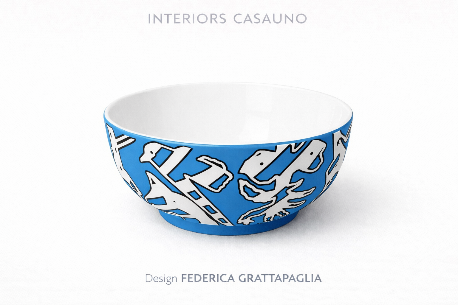 Blue ceramic bowl with black and white abstract design, displayed against a white background, with text "INTERIORS CASUAL" at the top and "Design FEDERICA GRATAPAGLIA" at the bottom.