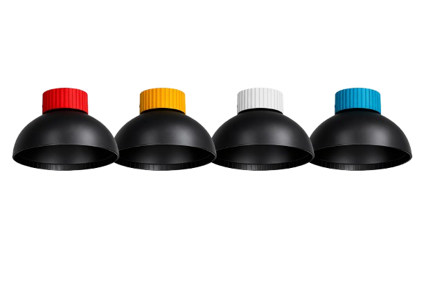 Four black, semi-spherical desk lamps with color-coded knobs: red, yellow, white, and blue, lined up in a row against a white background.