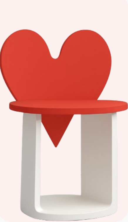 A children's chair with a red heart-shaped backrest, a red seat, and white legs.