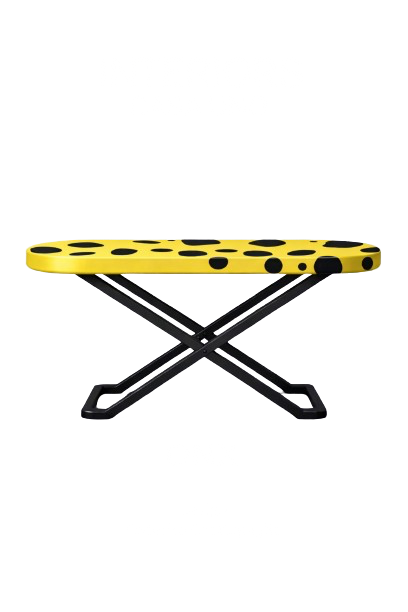 A yellow and black polka dot ironing board with a black adjustable stand. The word 'IMPOSURE' appears distorted at the top, and 'ONE M I N U T E' is written at the bottom in stylized text.