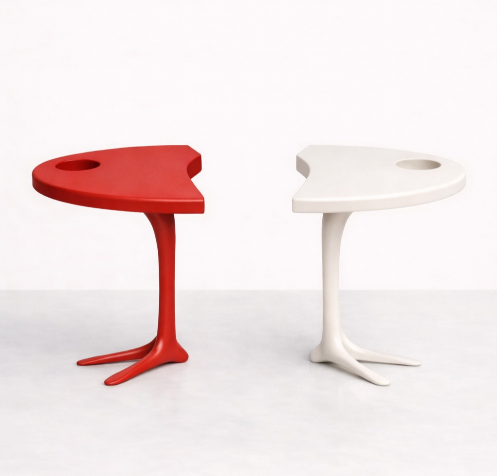 Red and white modern side tables with organic shapes and unique bases against a plain white background.