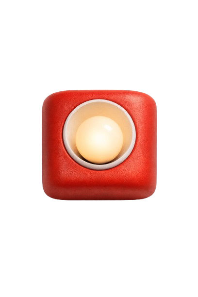 A red square-shaped electronic device with a white circular button in the center. Black text above and below the device is distorted and difficult to read.