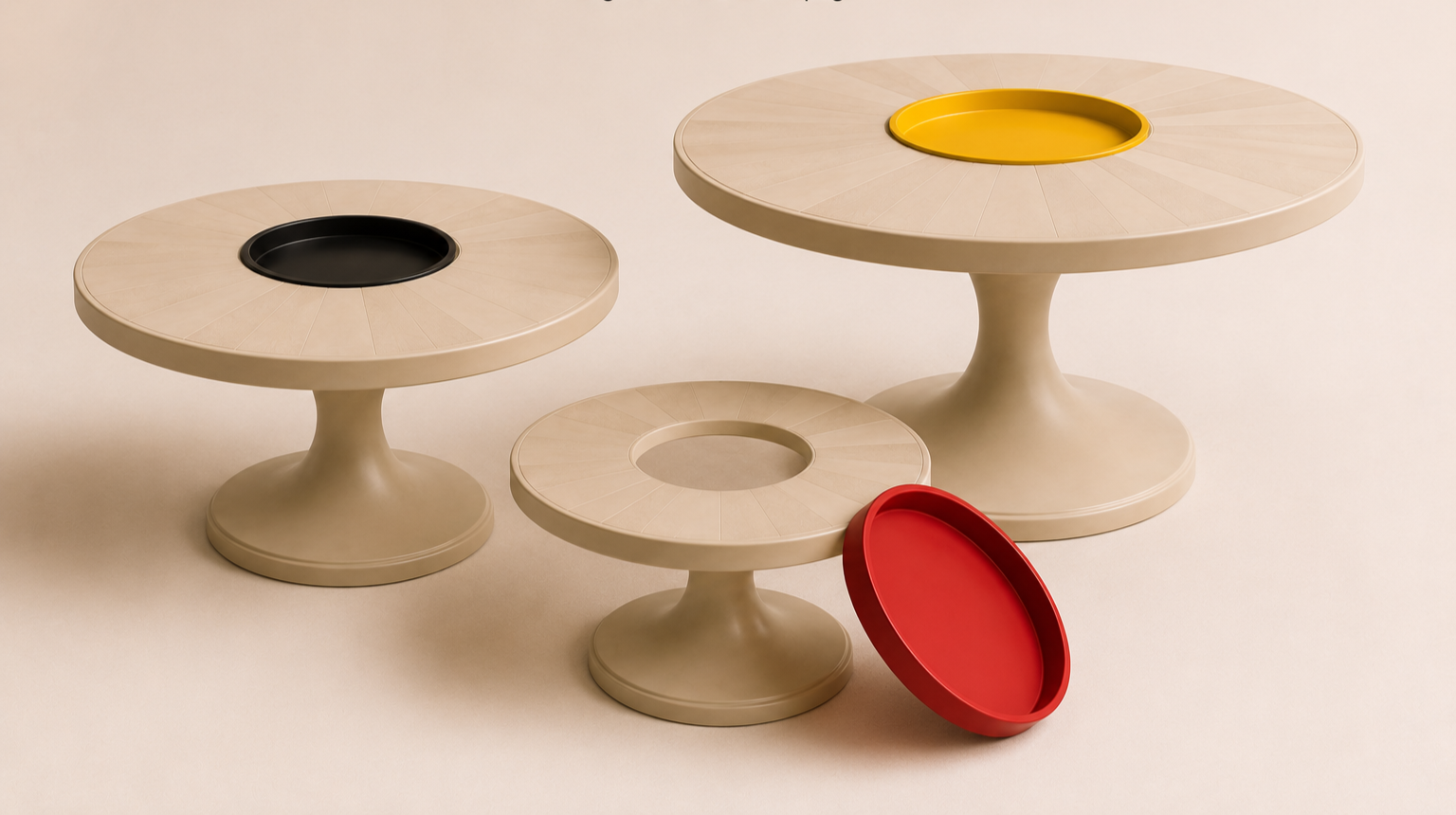 Three beige tables with circular tops and pedestal bases. The tables have contrasting colored trays in their centers: black on the left table, yellow on the right table, and red on the smaller middle table with a red tray resting on the floor.