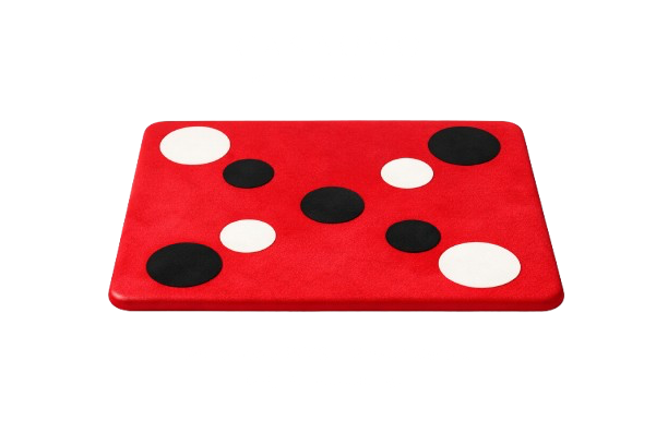 A red rectangular game board with black and white circular spots, resembling a ladybug design.