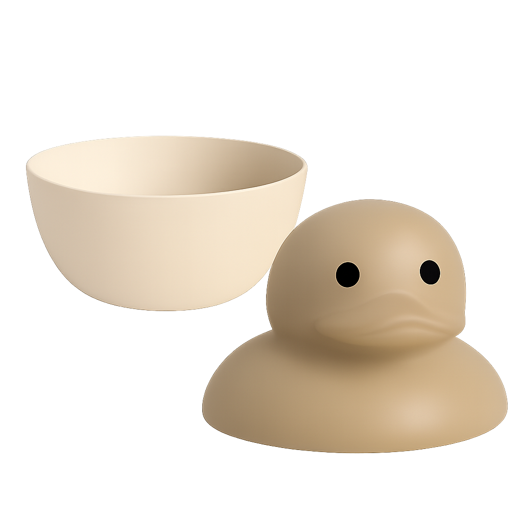 A beige rubber duck with a rounded head and simple black eyes, positioned next to a matching beige bowl.