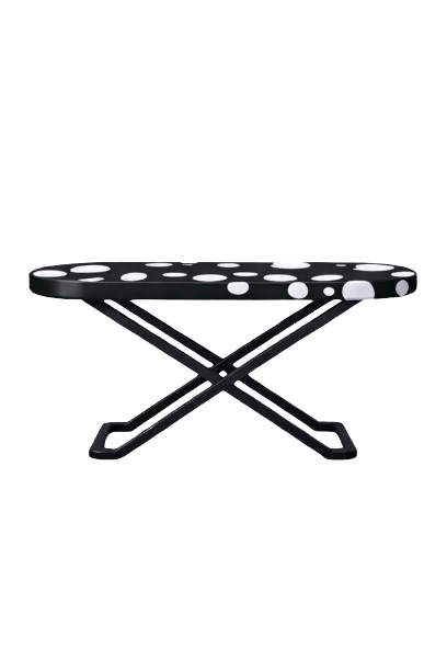 A black and white polka dot folding bench or footstool with a modern design.