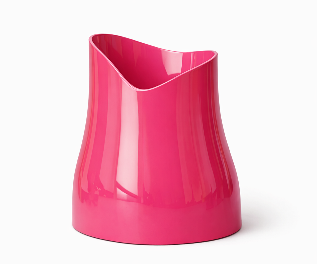 Bright pink ceramic vase with an asymmetrical, modern design on a white background.