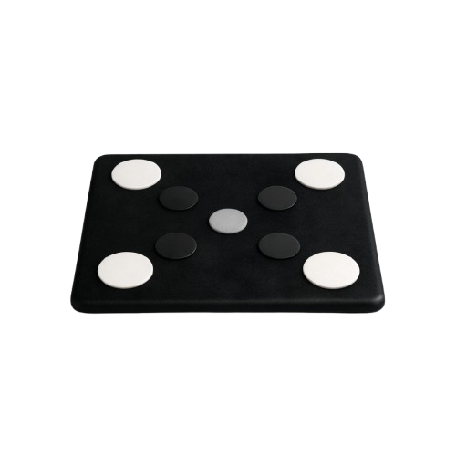 Black and white checkered pattern with circular spots on a surface.