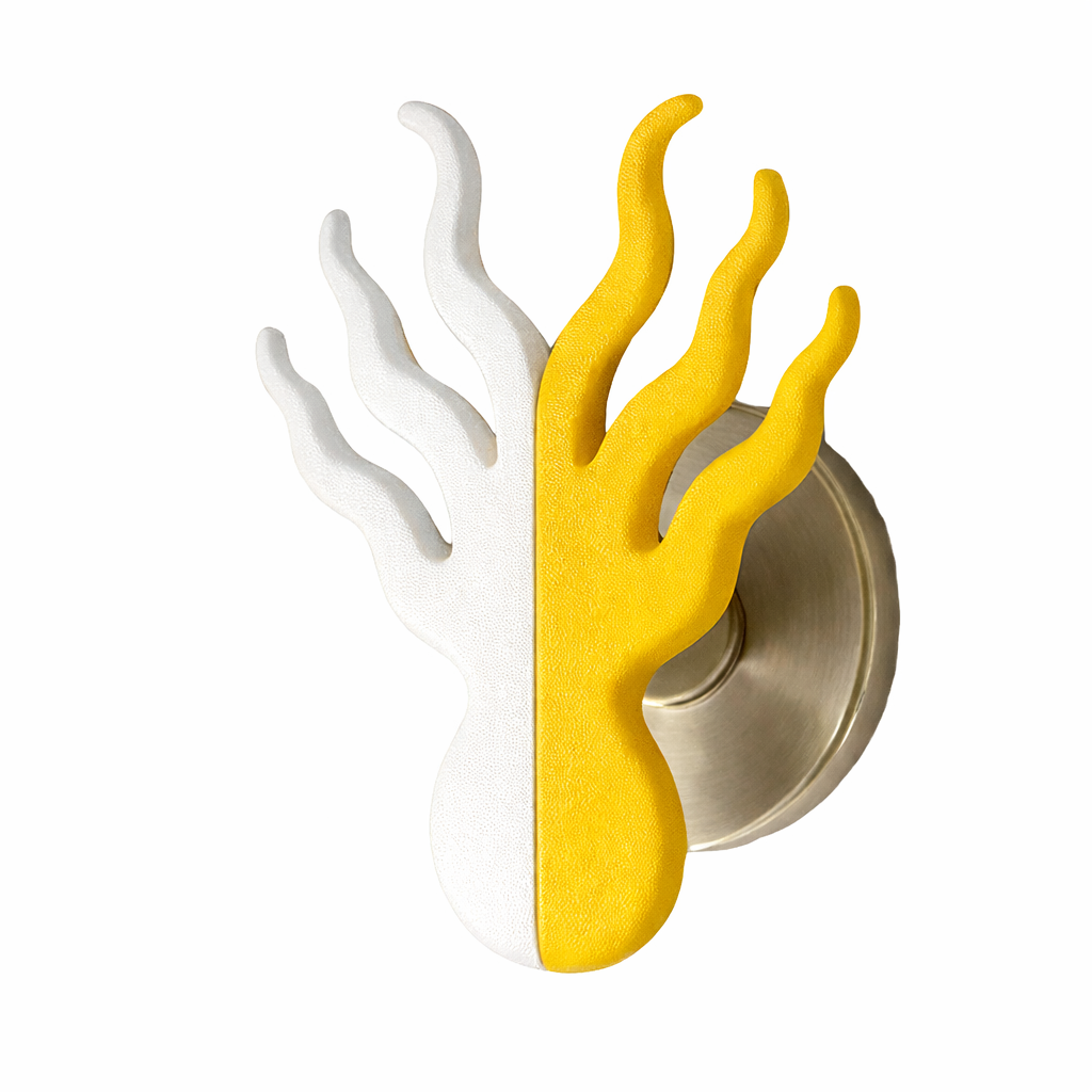 Decorative wall hook shaped like a hand with two-tone color design, white on one side and yellow on the other, mounted on a circular metal base.